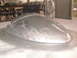 1994 Ford Bronco - Custom fender with an etched pattern and a side mirror attached, likely in a workshop setting.